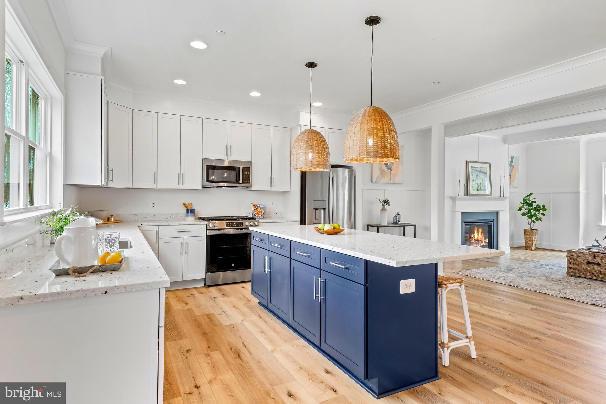 6016 Drum Point Road Deale, MD 20751 - Photo 6 of 42 a kitchen with a stove a sink dishwasher a refrigerator and a dining table with wooden floor