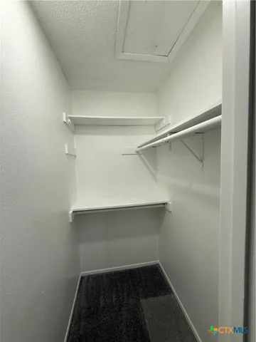 a empty walk in closet with a window