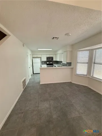 a view of a kitchen with a sink and a window