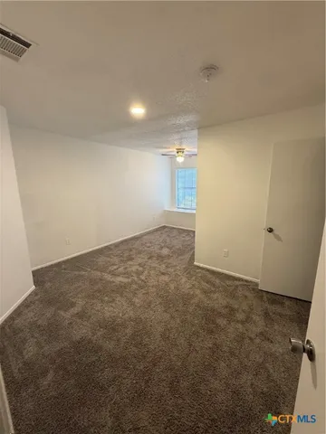 an empty room with a empty space and windows