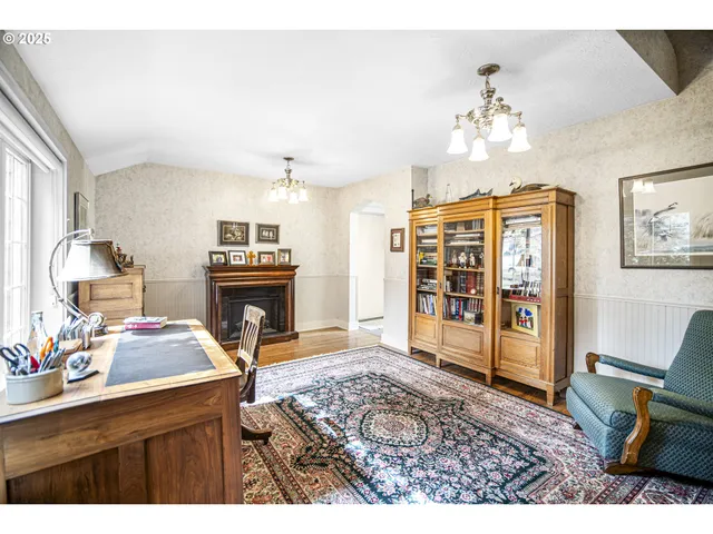 a living room with furniture a chandelier and a fireplace