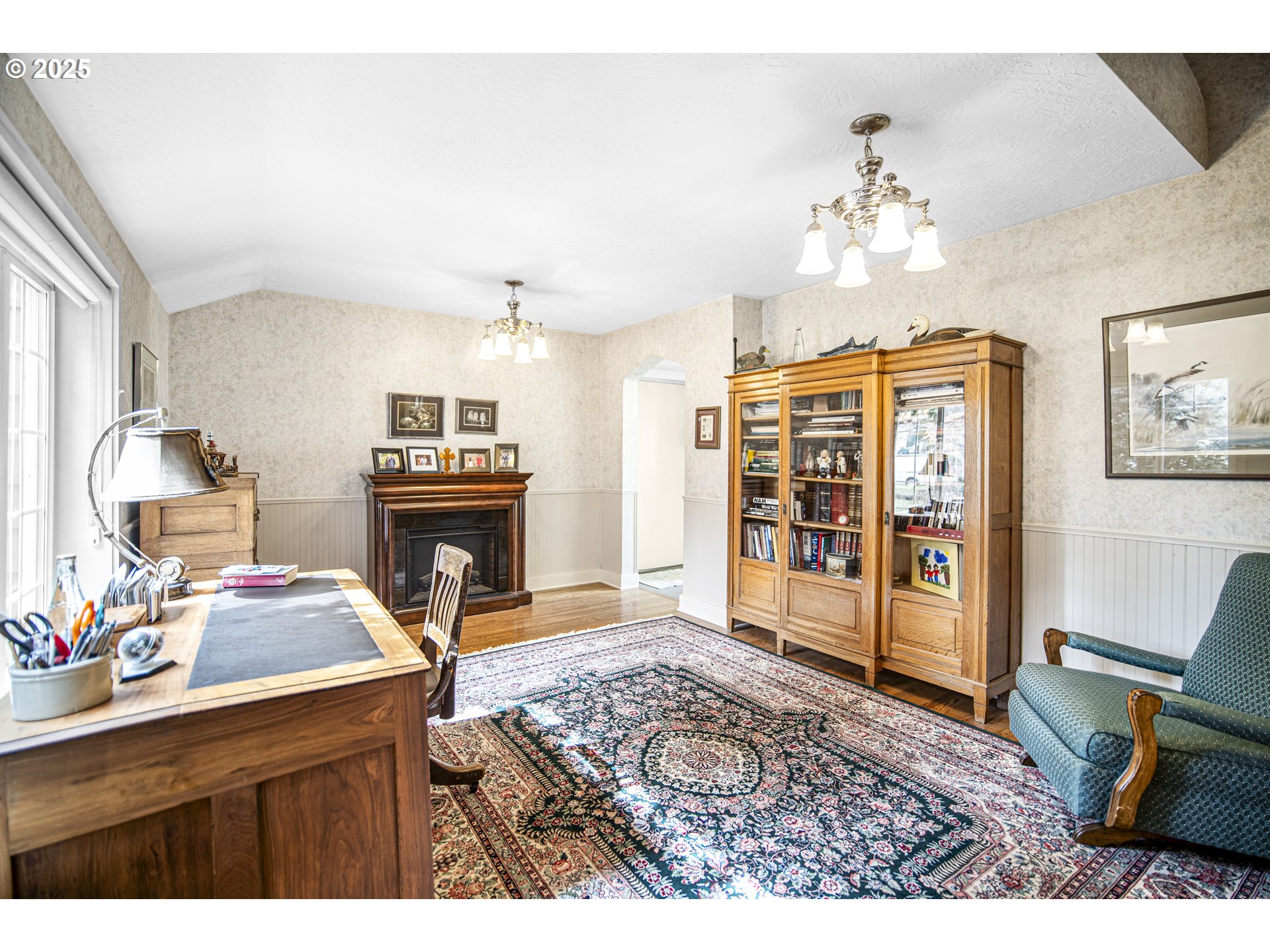 898 Northwest Riverside Boulevard Bend, OR 97703 - Photo 15 of 32 a living room with furniture a chandelier and a fireplace