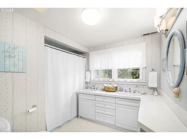 a kitchen with a refrigerator sink and cabinets
