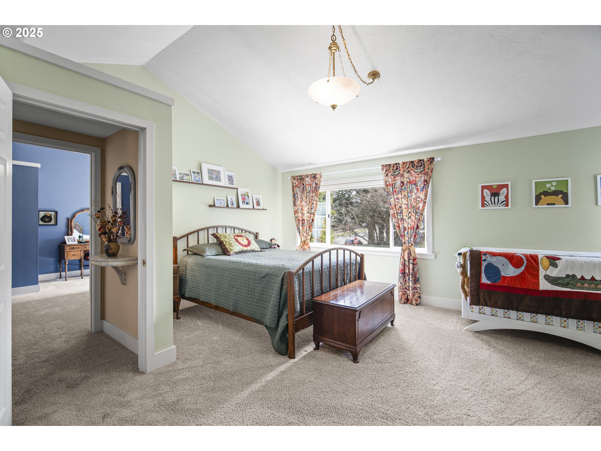 898 Northwest Riverside Boulevard Bend, OR 97703 - Photo 24 of 32 a bedroom with a bed and a chandelier