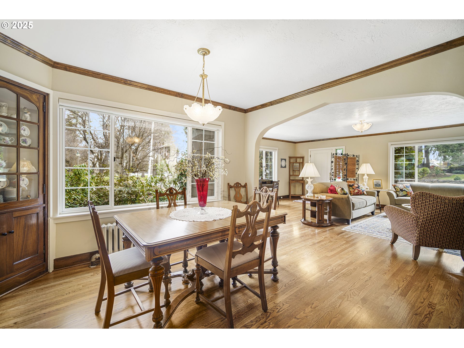 898 Northwest Riverside Boulevard Bend, OR 97703 - Photo 6 of 32 a view of a dining room and livingroom with furniture wooden floor a chandelier
