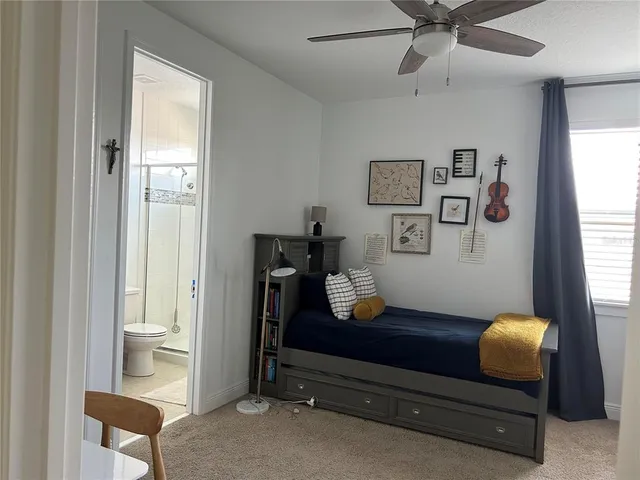 a living room with furniture and large windows
