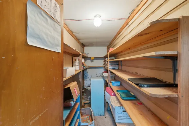 a view of an empty room with window and cabinet