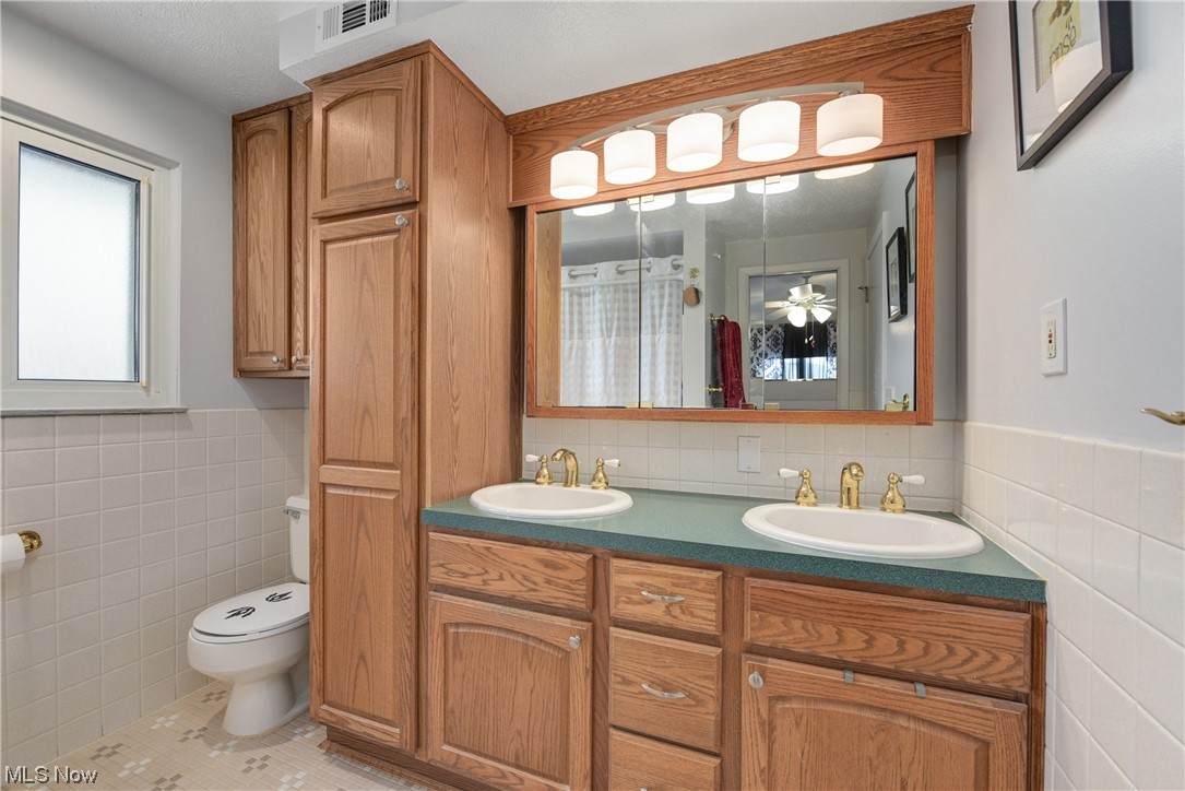 7094 Brandywine Road Parma Heights, OH 44130 - Photo 35 of 49 Bathroom with toilet, tile walls, double sink, and tile flooring