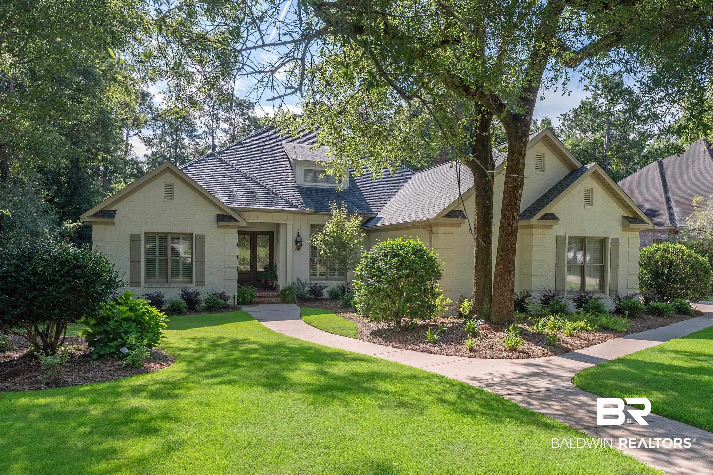 115 Sandy Ford Road Fairhope, AL 36532 - Photo 46 of 47 View of front of house featuring a front lawn, roof with shingles, french doors, and stone siding