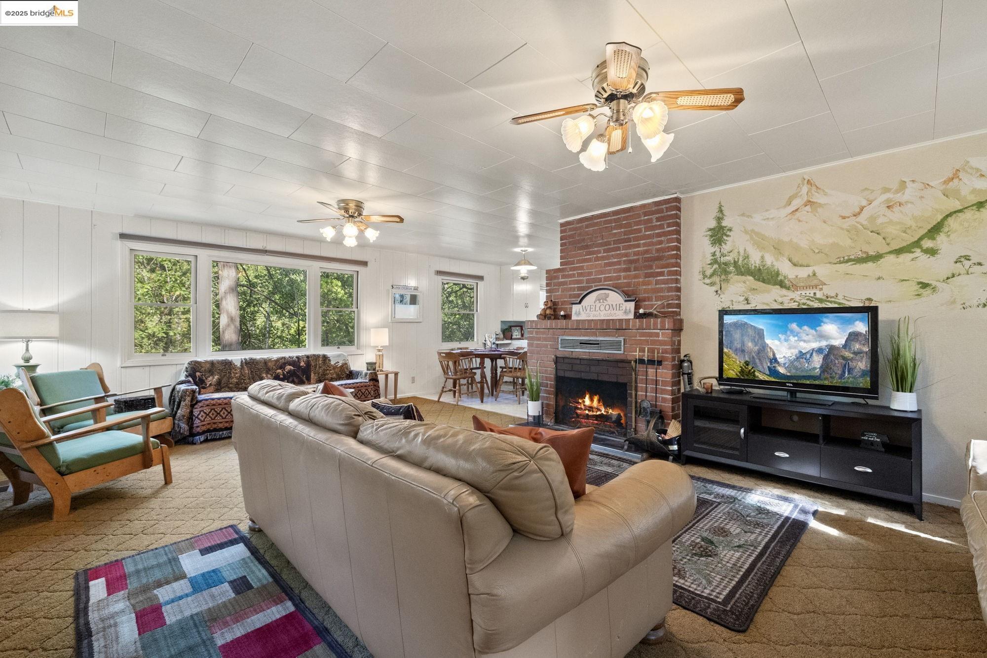 21705 Cedar Springs Road Twain Harte, CA 95383 - Photo 1 of 1 a living room with fireplace furniture and a flat screen tv