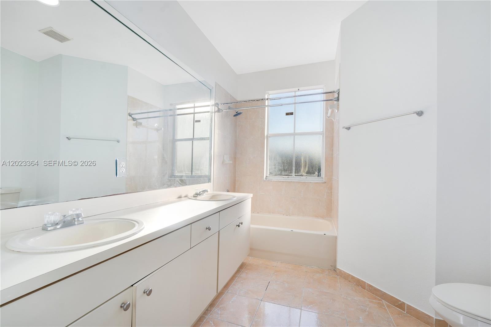 27433 Southwest 137th Court, Unit 1 Homestead, FL 33032 - Photo 18 of 28 a bathroom with a sink a toilet and vanity