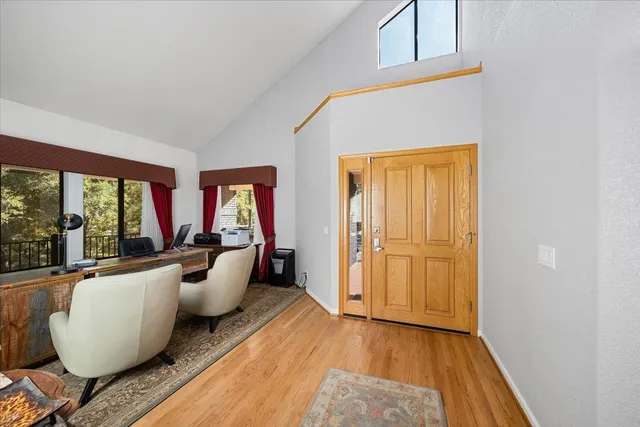 a kitchen with stainless steel appliances granite countertop a stove a sink dishwasher and a refrigerator with wooden floor