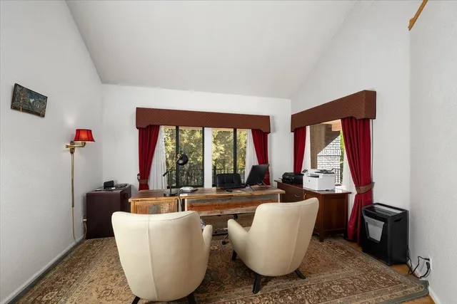 a kitchen with stainless steel appliances a stove a sink dishwasher a refrigerator and white cabinets with wooden floor