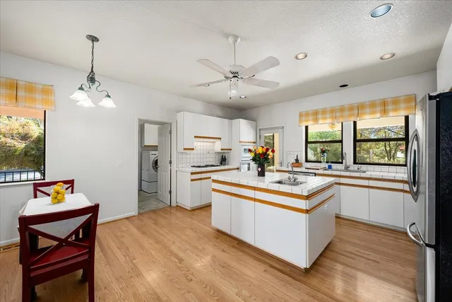 a kitchen with stainless steel appliances a stove sink and cabinets