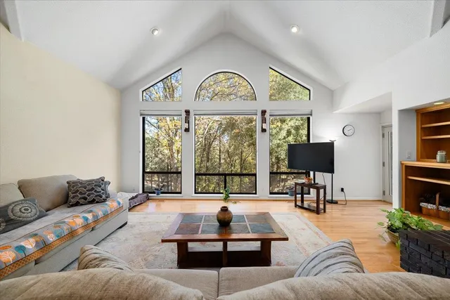 a living room with furniture and a wooden floor