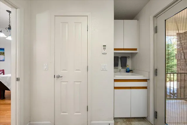 a white painted room with a potted plant