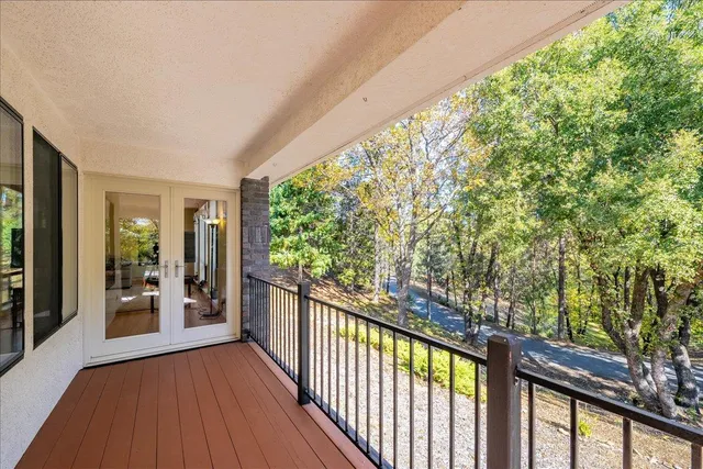 a living room with furniture and large windows