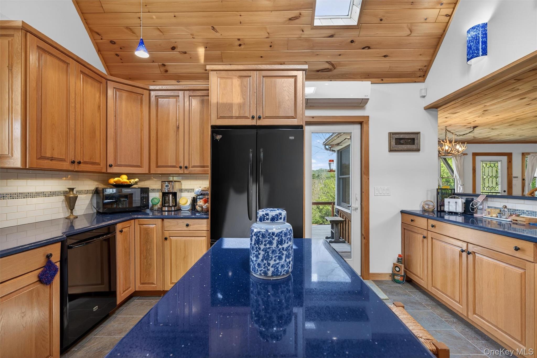340 Hospital Road Callicoon, NY 12723 - Photo 9 of 41 a kitchen with stainless steel appliances granite countertop a refrigerator a sink dishwasher a stove and white countertops with wooden floor