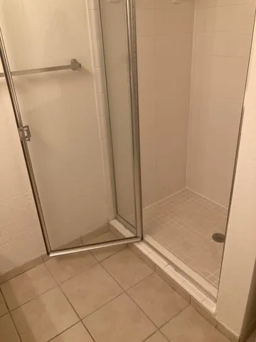 a bathroom with a toilet and a shower