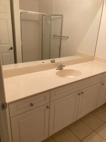 a bathroom with a glass shower door