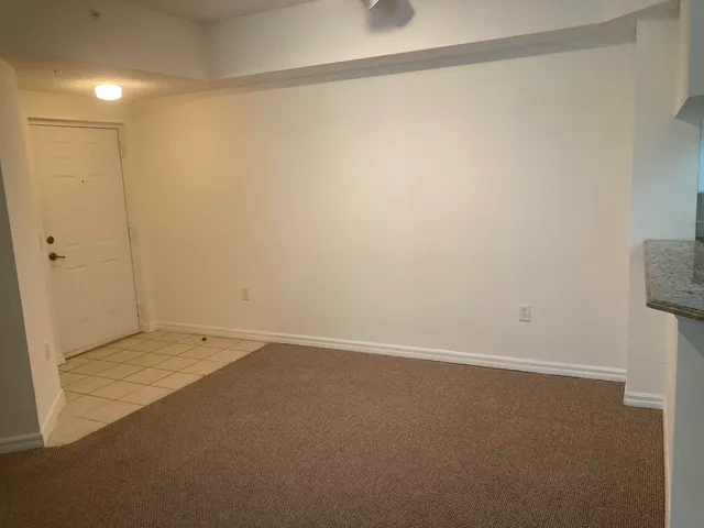 a kitchen with cabinets and a refrigerator