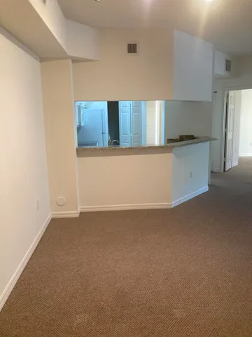 a kitchen with granite countertop a sink and a stove