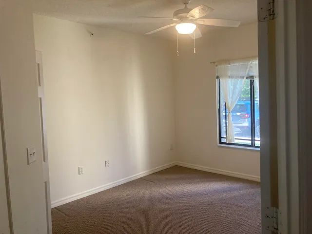 a white refrigerator freezer and a stove sitting inside of a kitchen