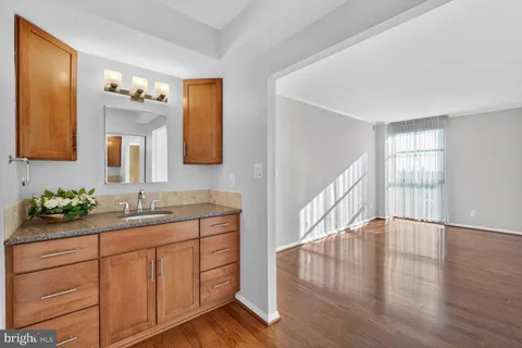 a view of an empty room with wooden floor