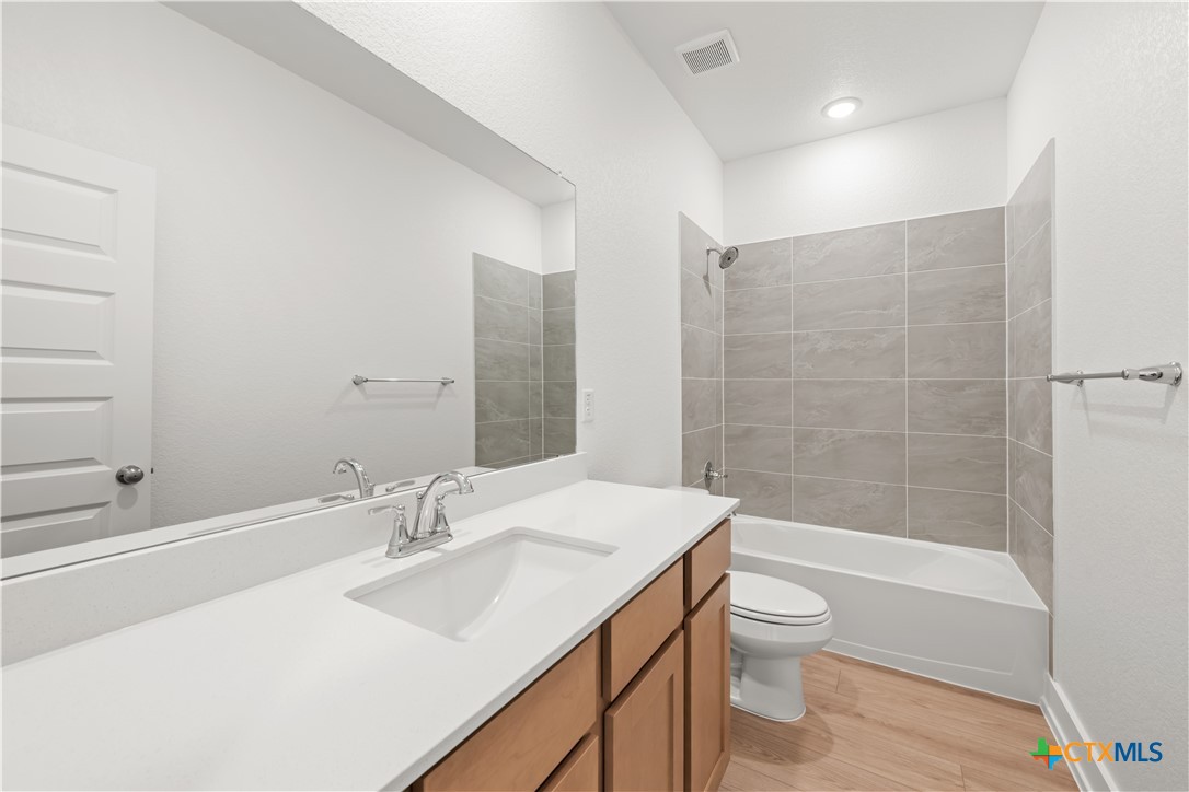 1218 Cilantro Road Temple, TX 76501 - Photo 14 of 16 a bathroom with a sink a toilet and shower