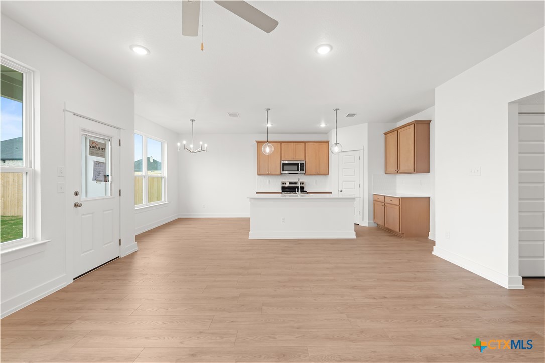 1218 Cilantro Road Temple, TX 76501 - Photo 6 of 16 a view of a kitchen with kitchen island wooden floor center island and stainless steel appliances