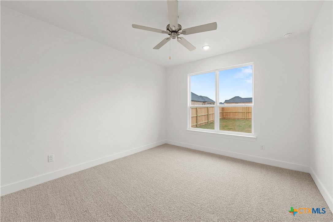1218 Cilantro Road Temple, TX 76501 - Photo 9 of 16 an empty room with a window and a ceiling fan