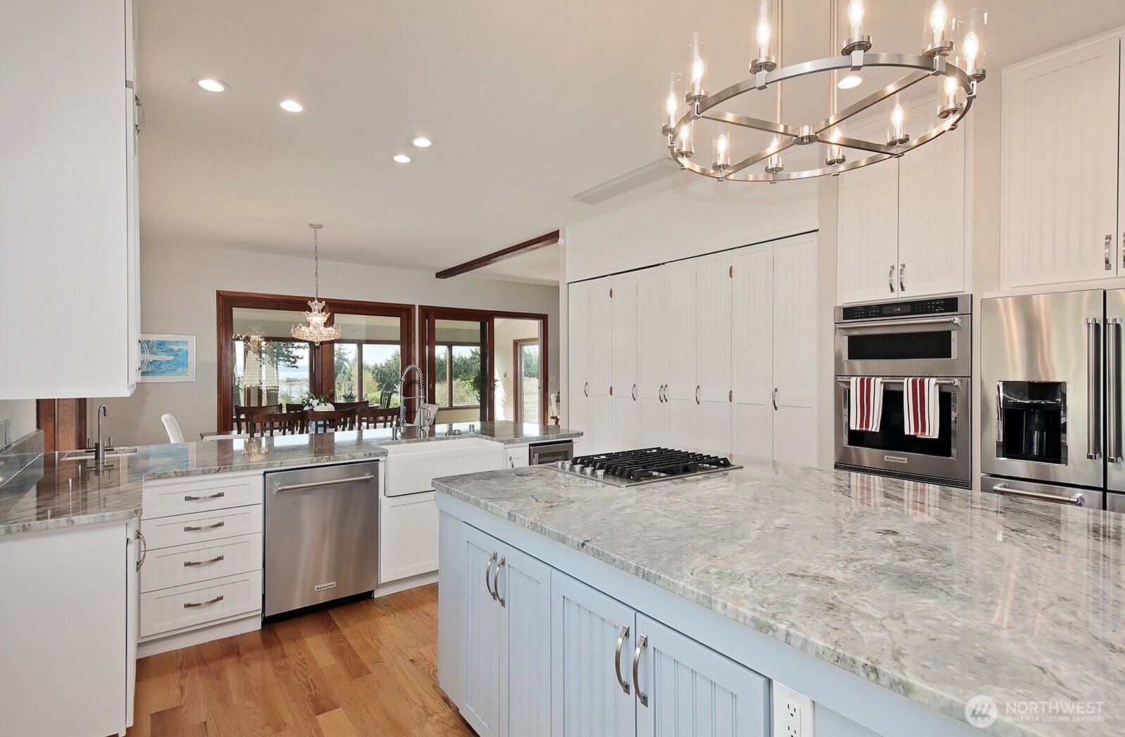 5741 Crow Haven Road Langley, WA 98260 - Photo 23 of 40 a kitchen with stainless steel appliances granite countertop a sink a stove and cabinets