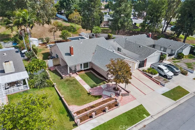 an aerial view of a house with a garden and swimming pool