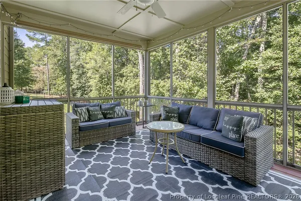 a living room with furniture and a rug