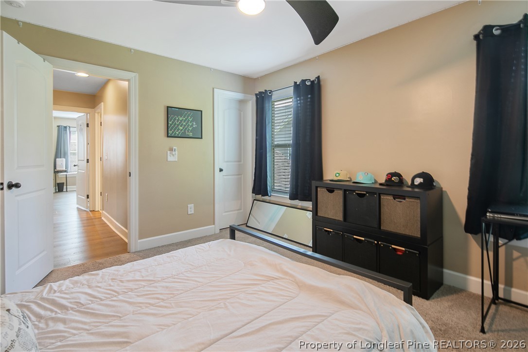 16 Spring Pond Lane Spring Lake, NC 28390 - Photo 25 of 33 a bedroom with a bed and wooden floor