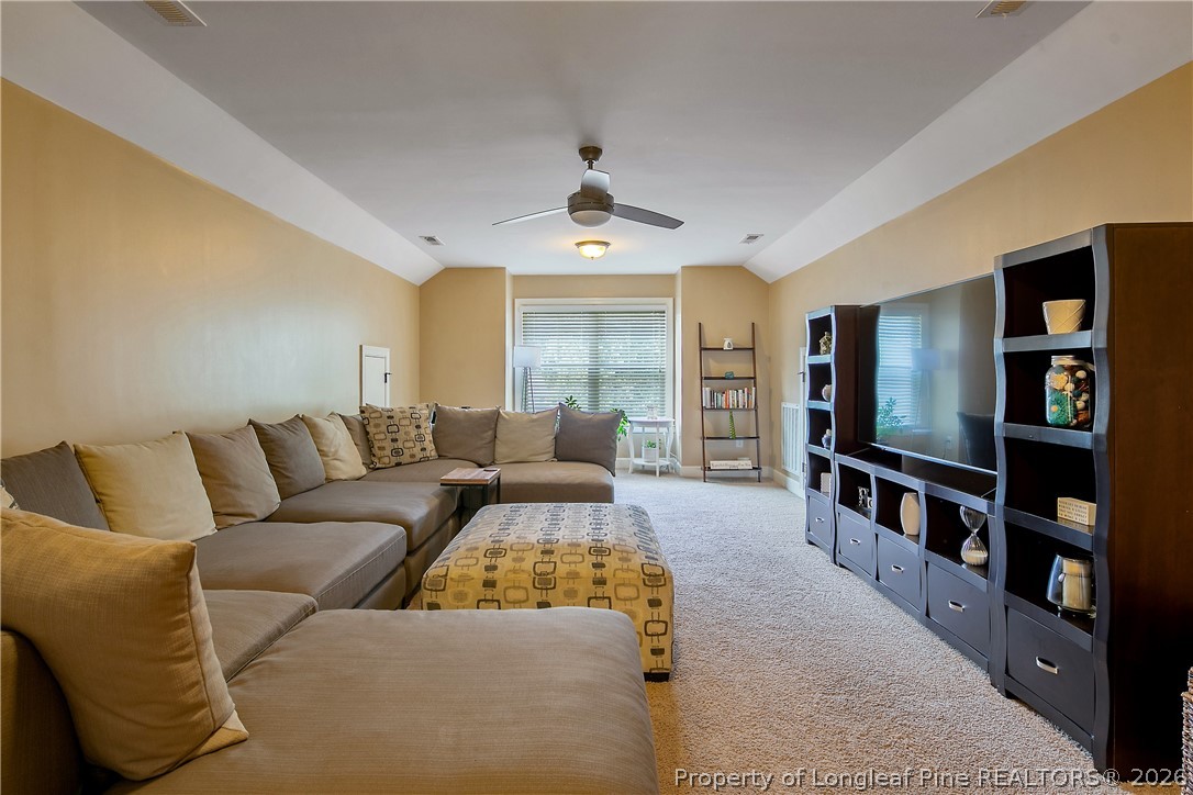 16 Spring Pond Lane Spring Lake, NC 28390 - Photo 26 of 33 a living room with furniture and a flat screen tv