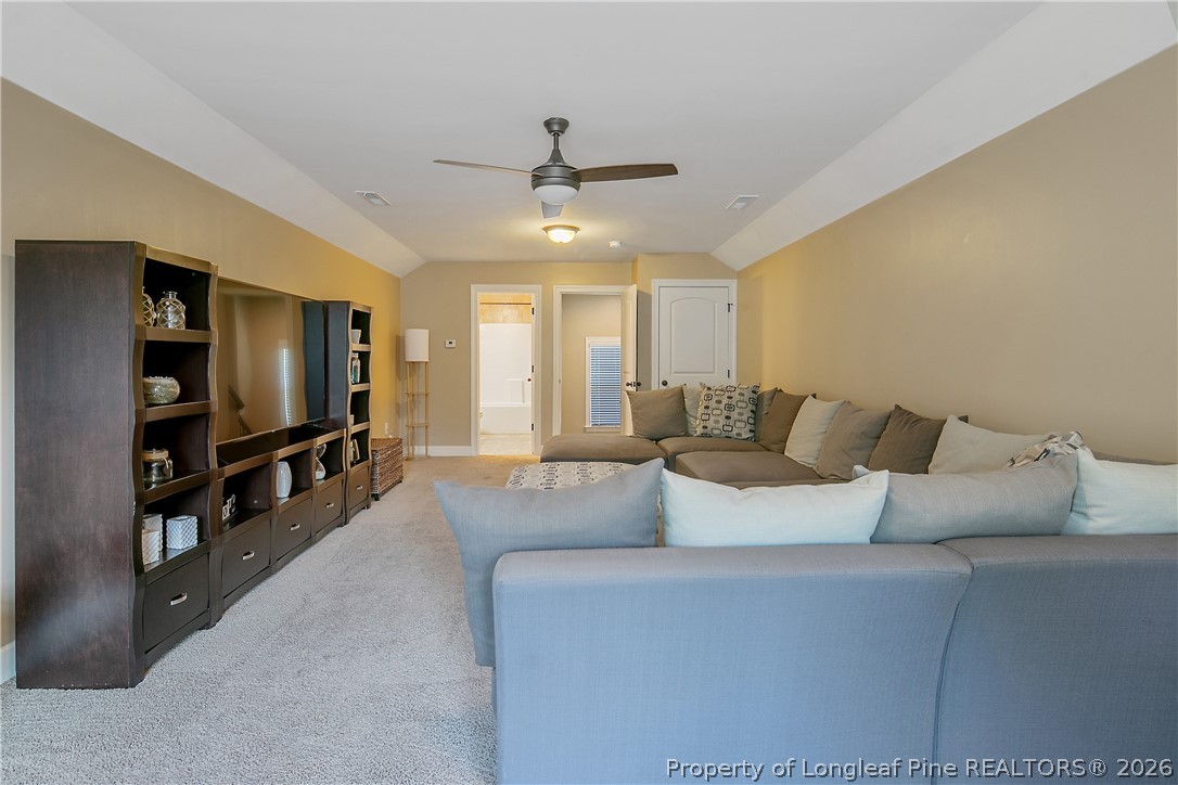 16 Spring Pond Lane Spring Lake, NC 28390 - Photo 27 of 33 a living room with furniture and a flat screen tv