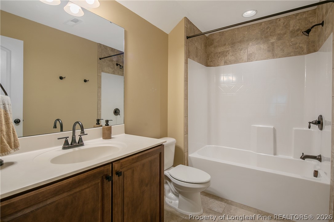 16 Spring Pond Lane Spring Lake, NC 28390 - Photo 28 of 33 a bathroom with a sink a toilet and a bathtub