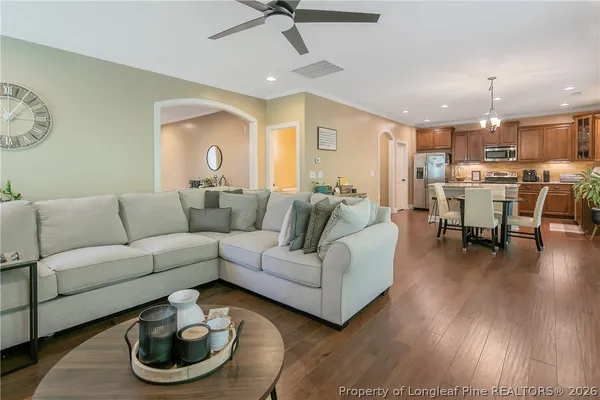 a living room with furniture and a wooden floor