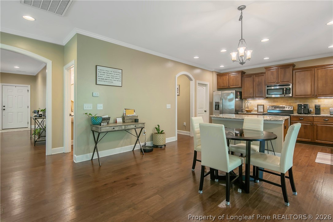 16 Spring Pond Lane Spring Lake, NC 28390 - Photo 6 of 33 a view of a dining room with furniture and wooden floor
