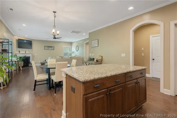 a kitchen with a table chairs and wooden floor