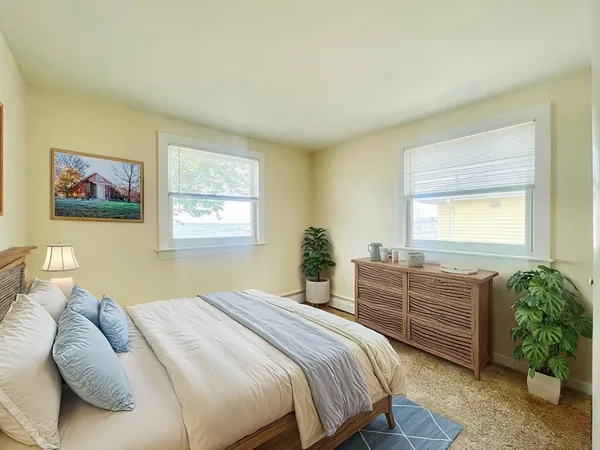 a kitchen with a refrigerator a sink and dishwasher with white cabinets