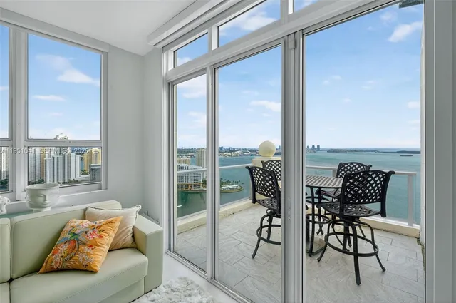 a living room with furniture and a floor to ceiling window
