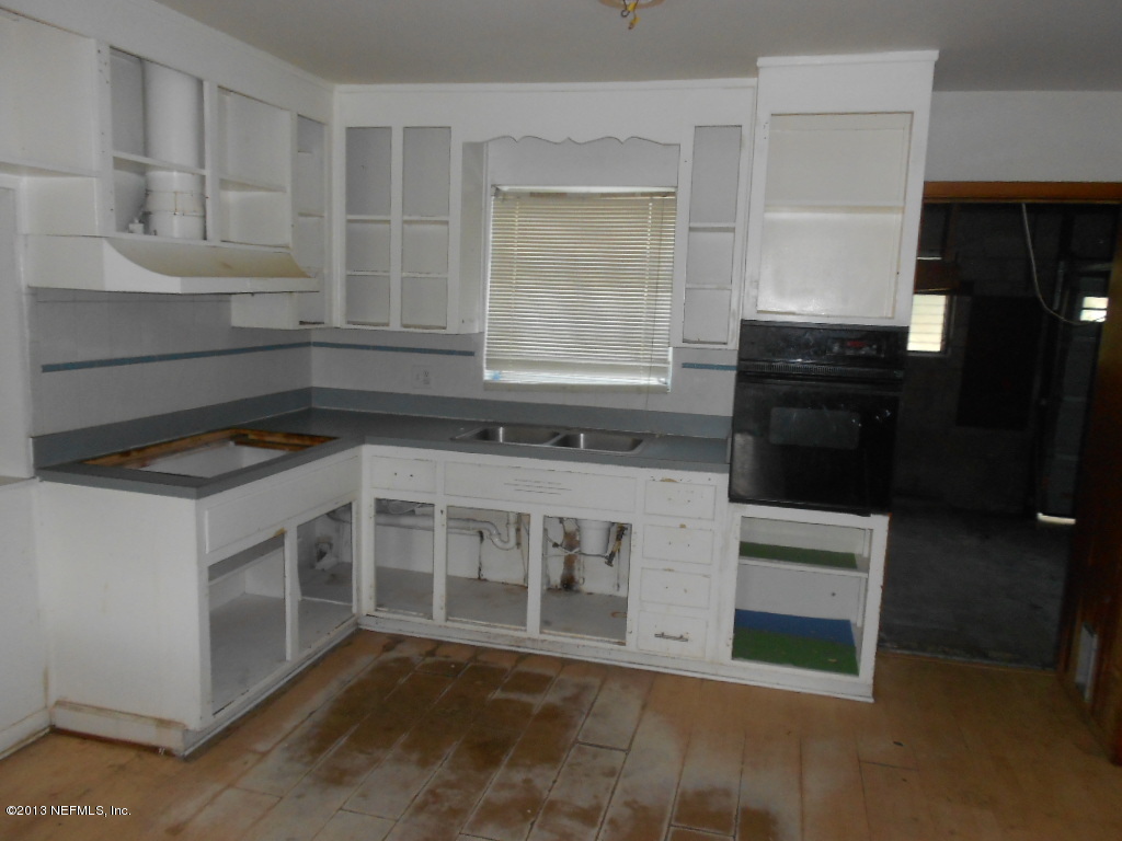 3765 Bess Road Jacksonville, FL 32277 - Photo 3 of 8 a kitchen with a stove and a sink