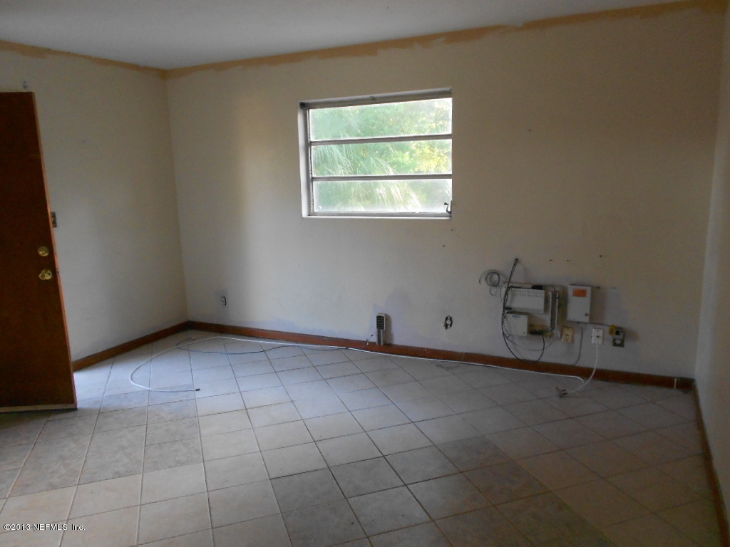 3765 Bess Road Jacksonville, FL 32277 - Photo 5 of 8 an empty room with a empty space and a window