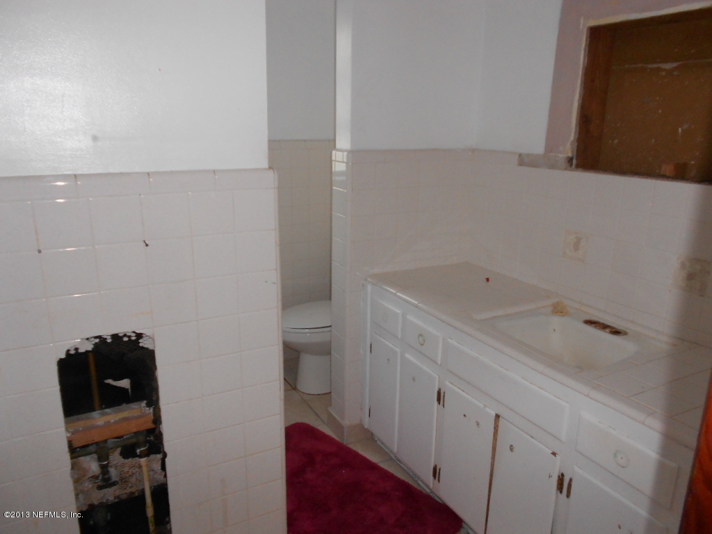 3765 Bess Road Jacksonville, FL 32277 - Photo 6 of 8 a bathroom with a sink and a toilet