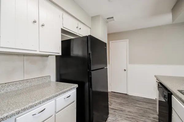 a kitchen with a refrigerator and cabinets