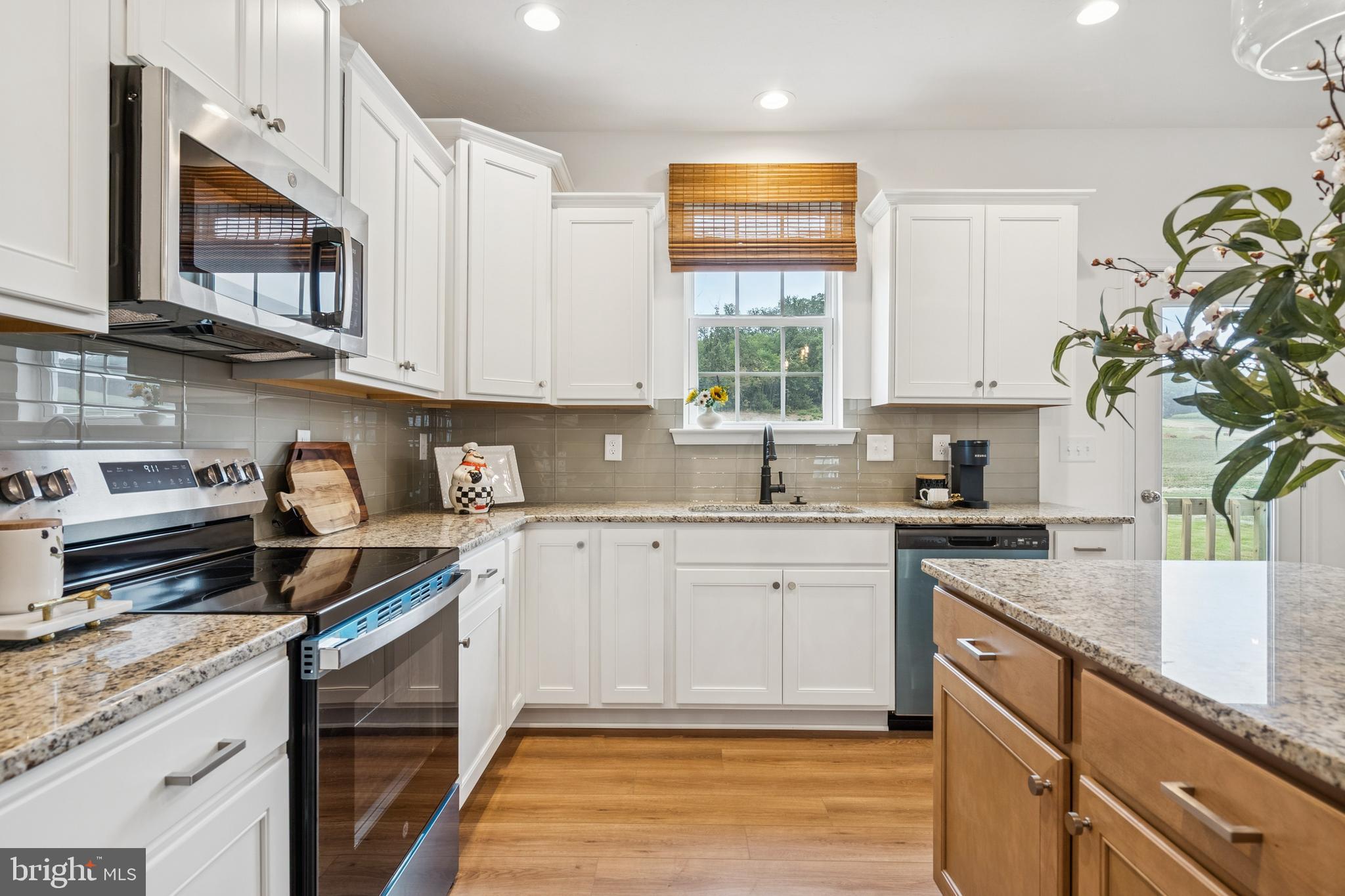 136 Piedmont Way, Unit 102 Hanover, PA 17331 - Photo 14 of 40 a kitchen with stainless steel appliances granite countertop a sink a stove top oven a counter space and cabinets
