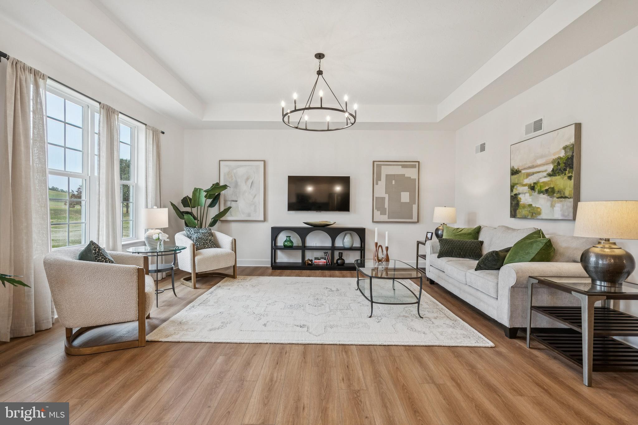 136 Piedmont Way, Unit 102 Hanover, PA 17331 - Photo 17 of 40 a living room with furniture a chandelier and a flat screen tv