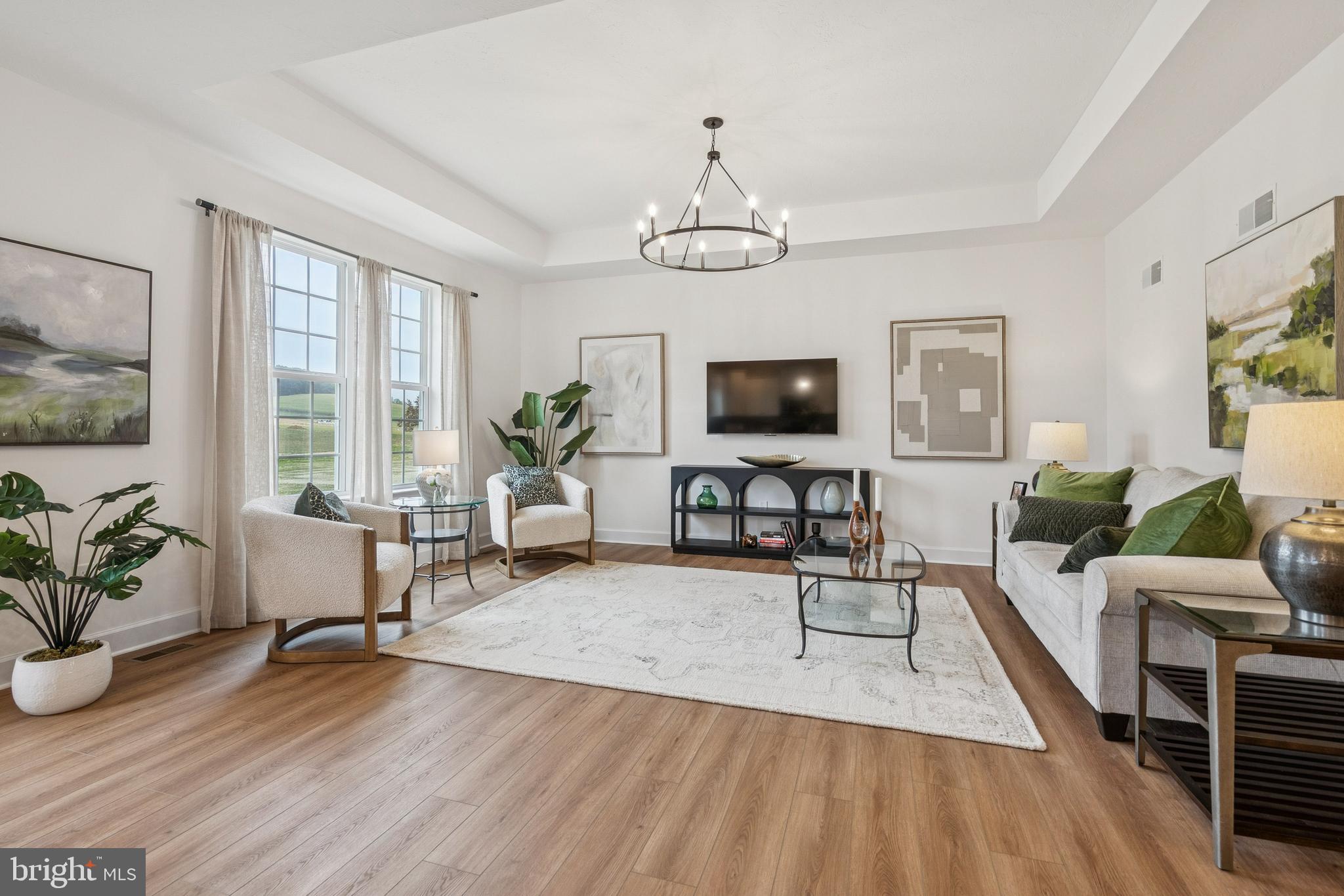 136 Piedmont Way, Unit 102 Hanover, PA 17331 - Photo 18 of 40 a living room with furniture a dining table and a flat screen tv
